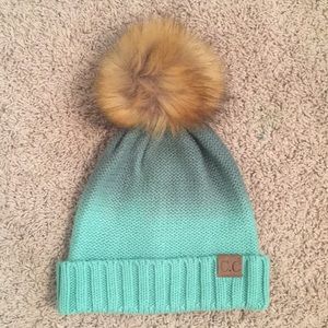 A teal ombre pom pom C.C. brand beanie